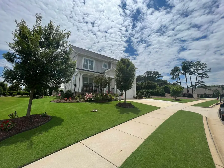 New sod lawn on a corner lot with young trees